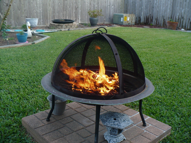 a fire burns in the firepit on the patio